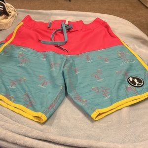 Men’s Baseballism swim short with flamingo/baseball pitcher print. Bring colors